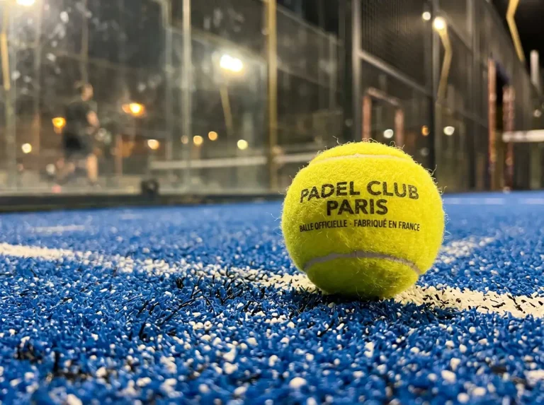 Gros plan sur une balle de padel posée sur le gazon synthétique d'un court, symbolisant le nouveau système Star Point 2026
